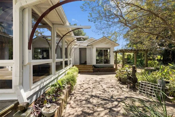a view of a kitchen with fridge and wooden floor