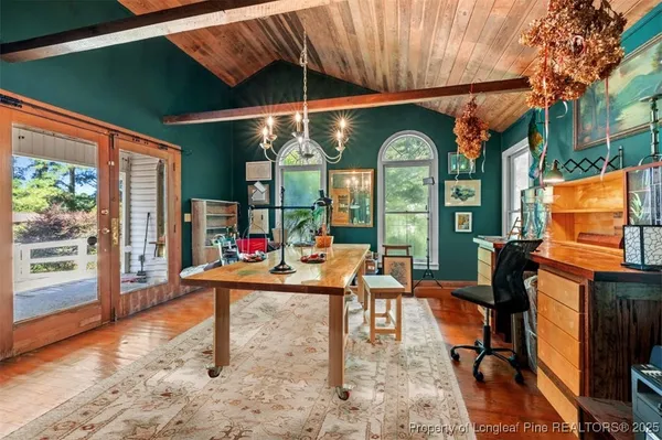 a living room with patio furniture and a floor to ceiling window
