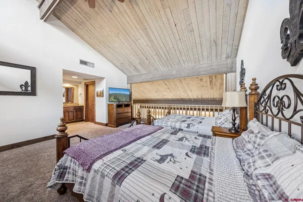 a bedroom with a bed and a television