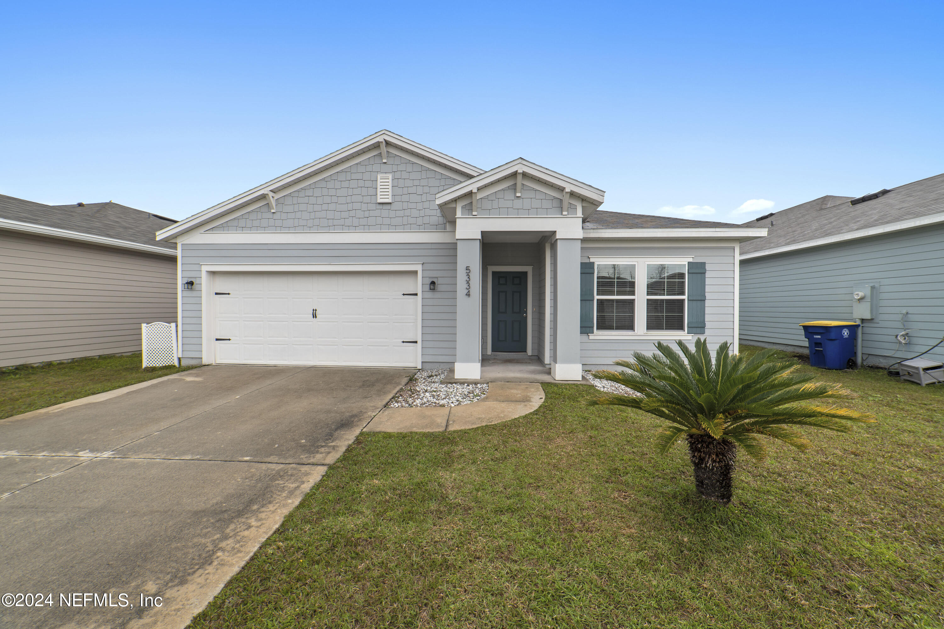 a view of a house with a yard and plants