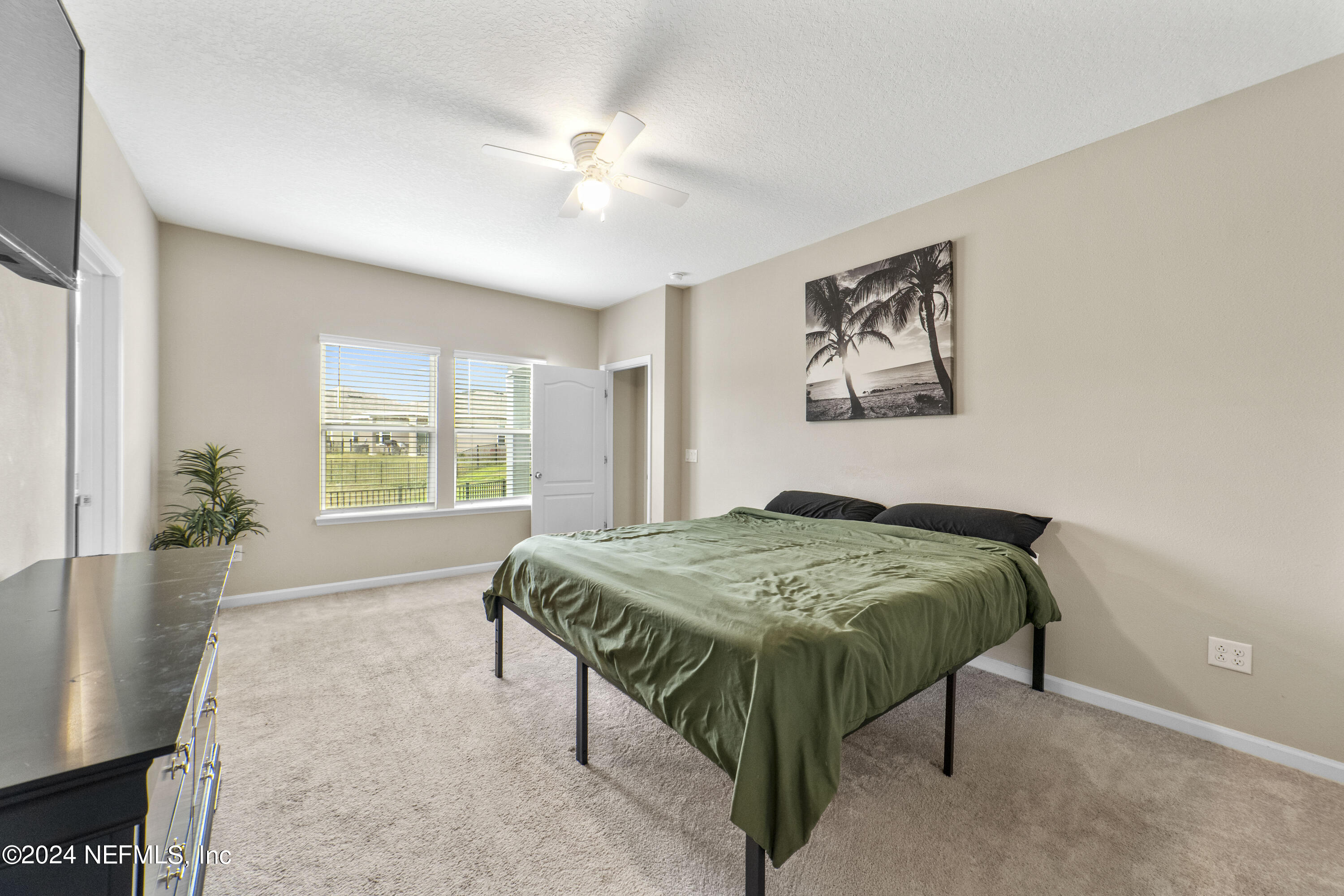 5334 Kellar Circle Jacksonville, FL 32218 - Photo 15 of 23 a bed sitting in a spacious bedroom next to a window