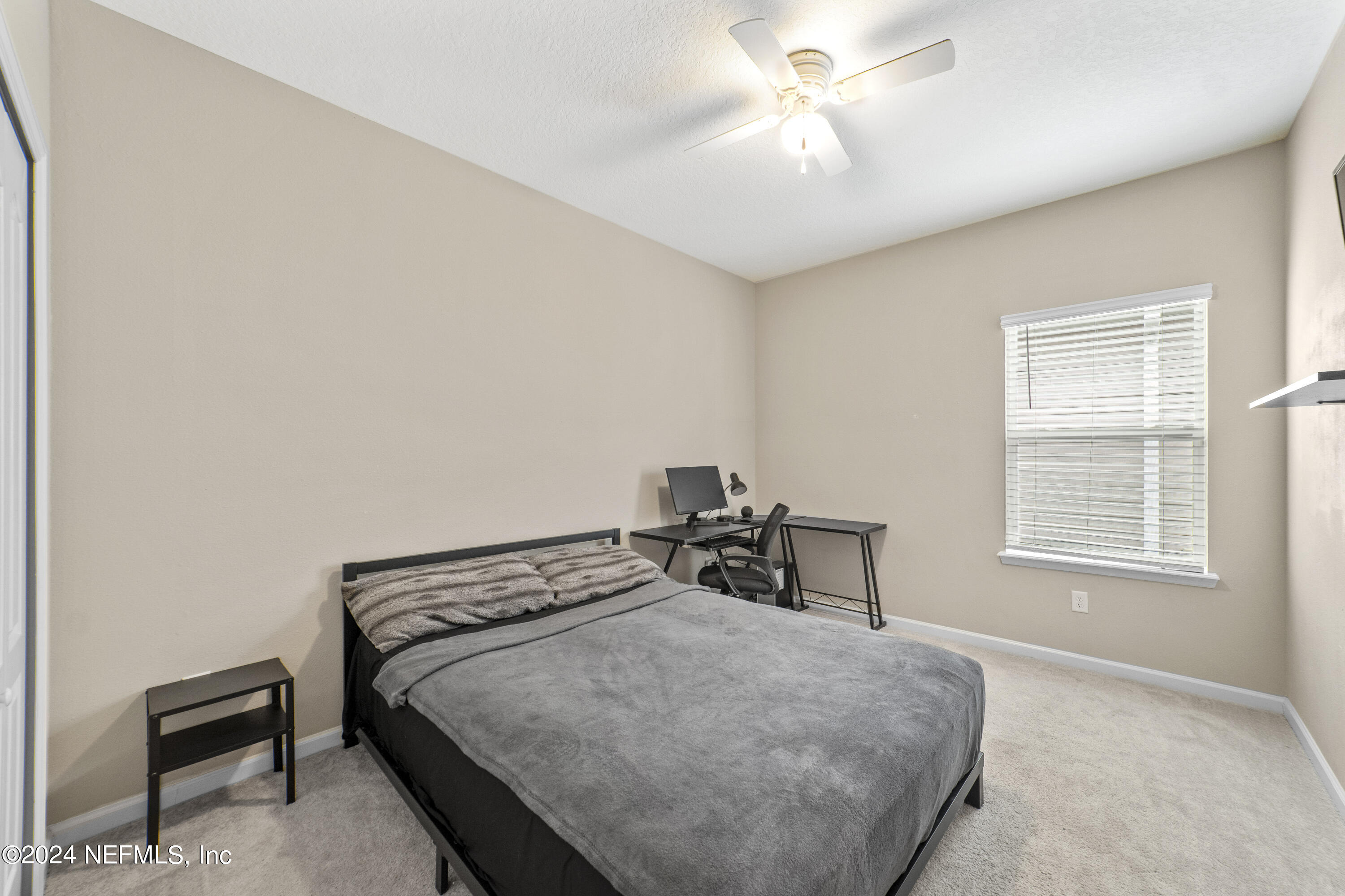5334 Kellar Circle Jacksonville, FL 32218 - Photo 21 of 23 a bedroom with a bed a chandelier and a window