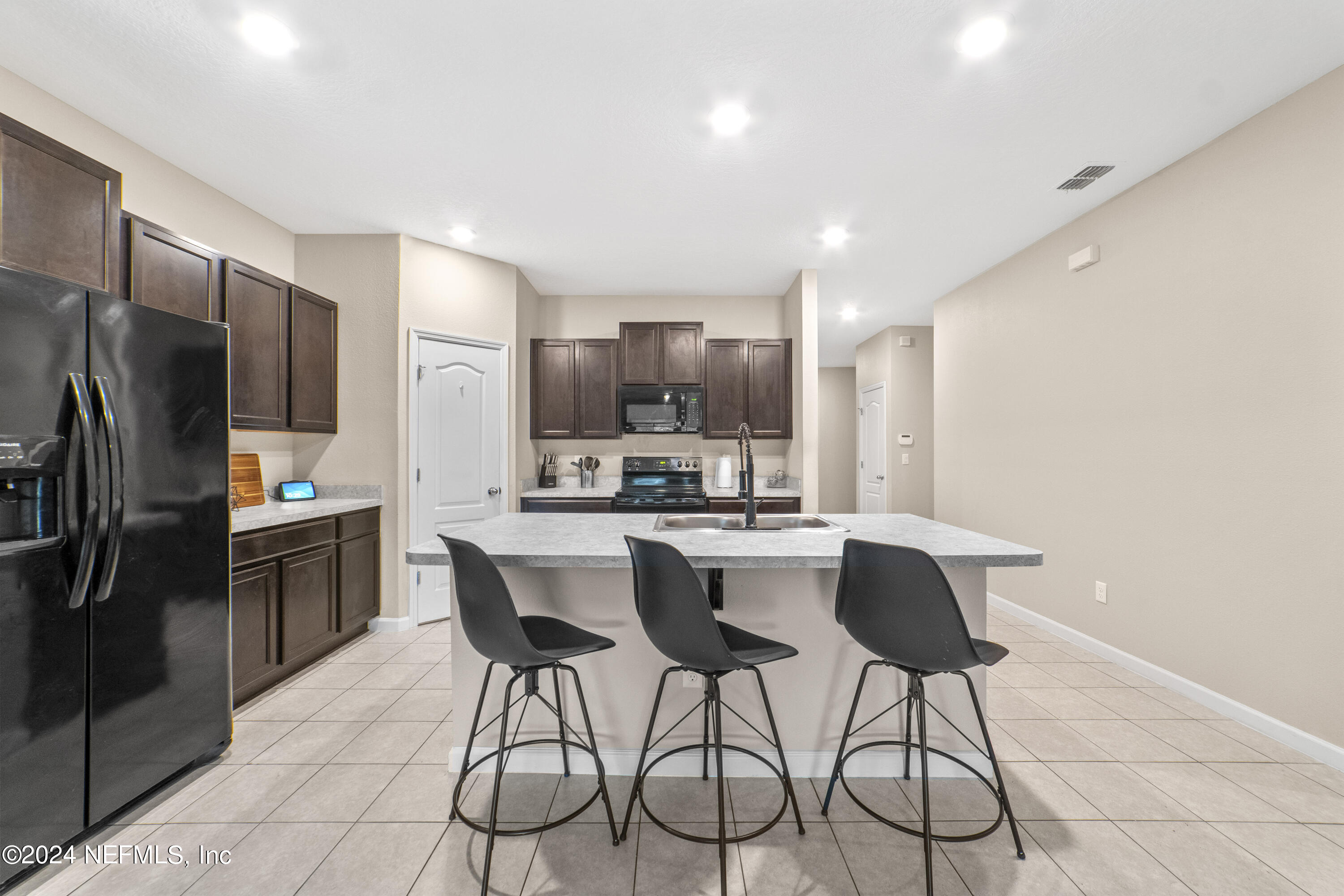 5334 Kellar Circle Jacksonville, FL 32218 - Photo 8 of 23 a kitchen with stainless steel appliances kitchen island granite countertop a refrigerator and a stove top oven