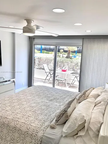 a bedroom with a large bed and a large window