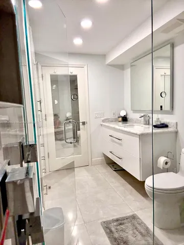 a bathroom with a double vanity sink a mirror and a bathtub