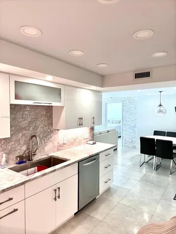 a spacious bathroom with a double vanity sink and a mirror
