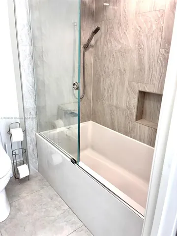 a bathroom with a bathtub and a shower