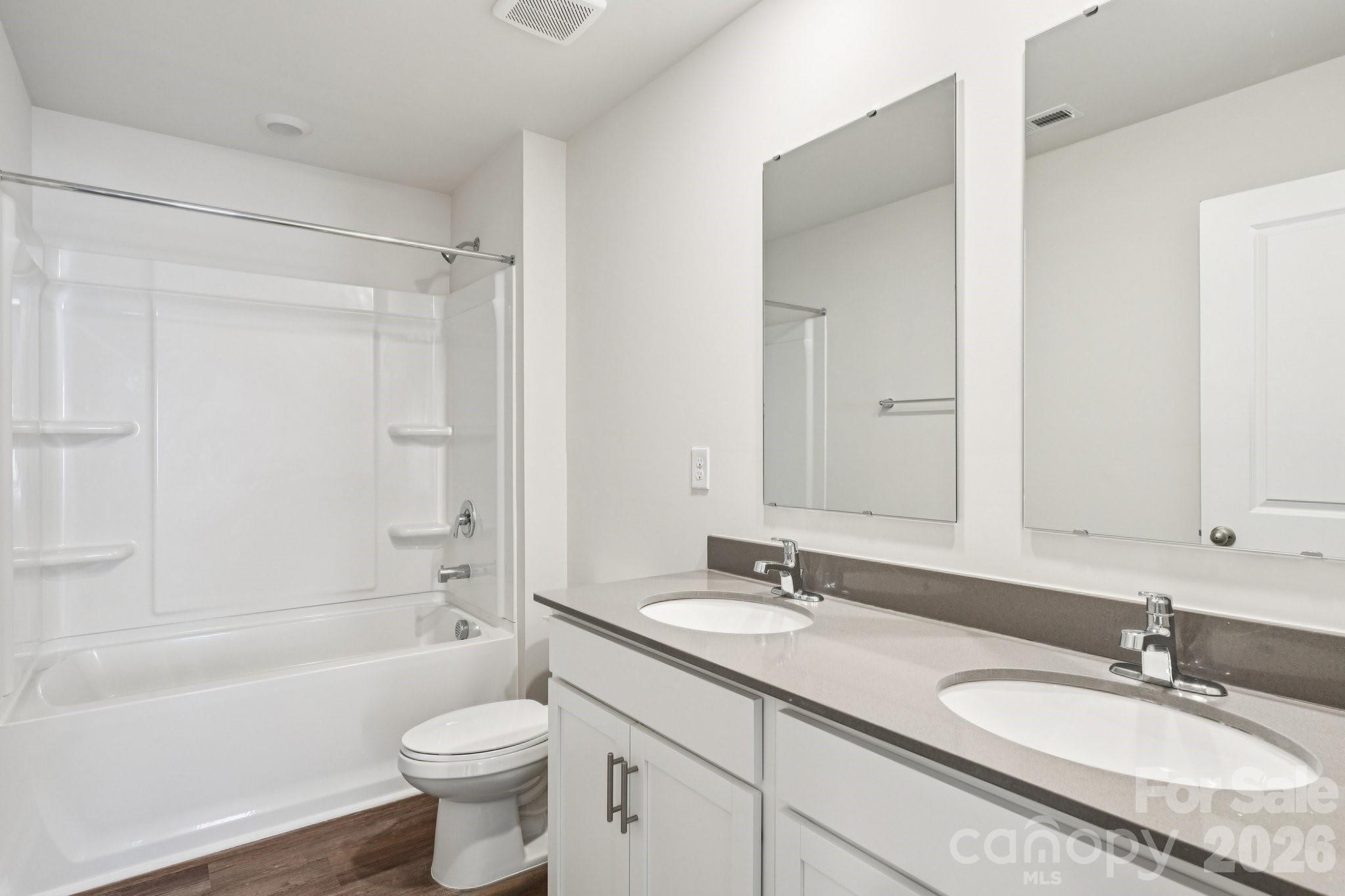 1430 Mammoth Road Hickory, NC 28602 - Photo 29 of 42 a bathroom with a granite countertop sink toilet mirror and bathtub