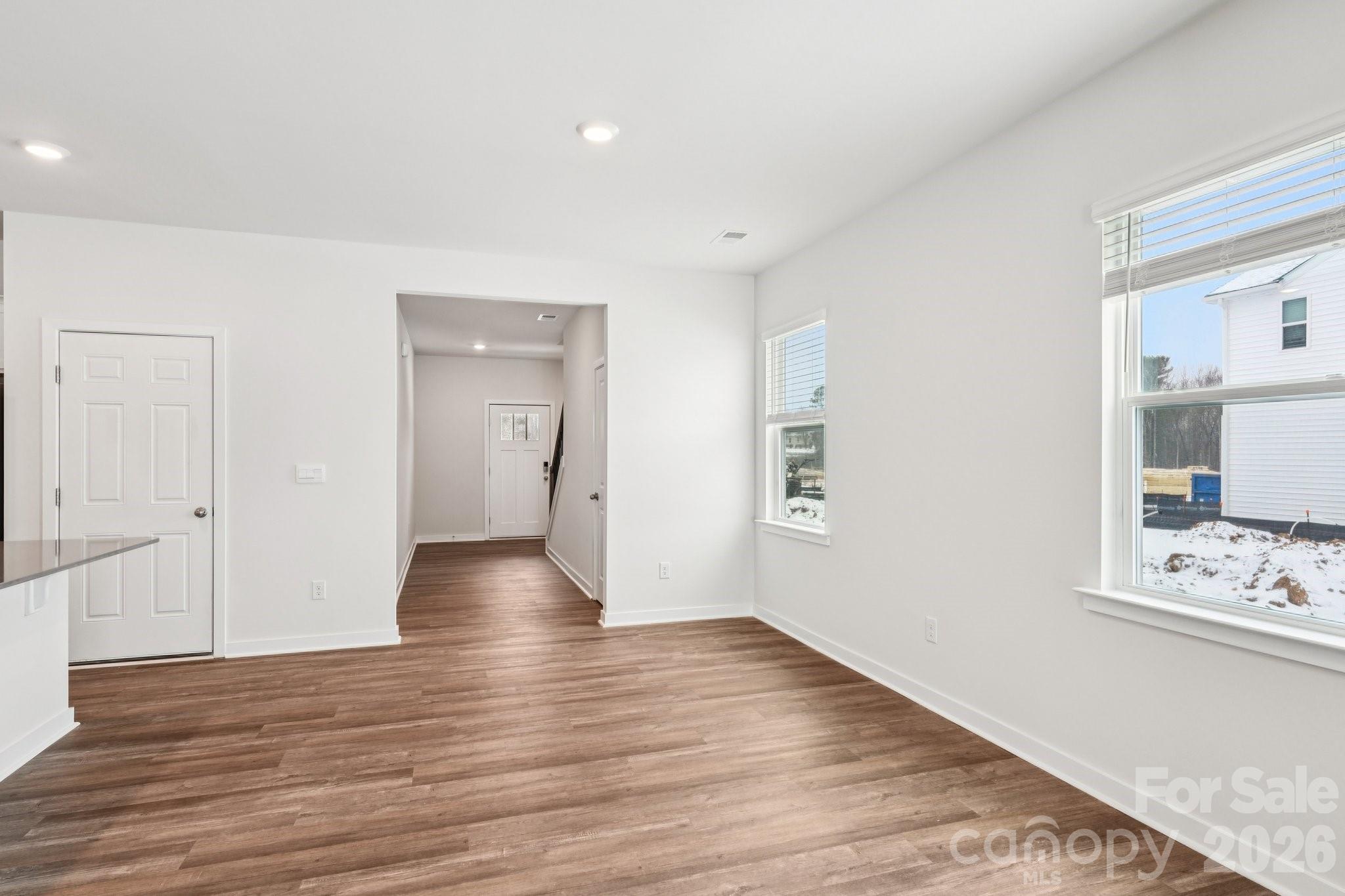 1430 Mammoth Road Hickory, NC 28602 - Photo 6 of 42 a view of an empty room with wooden floor and kitchen