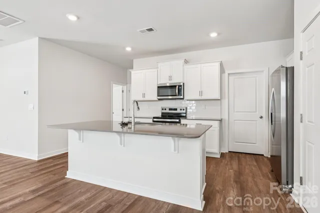 a kitchen with stainless steel appliances a sink stove and refrigerator