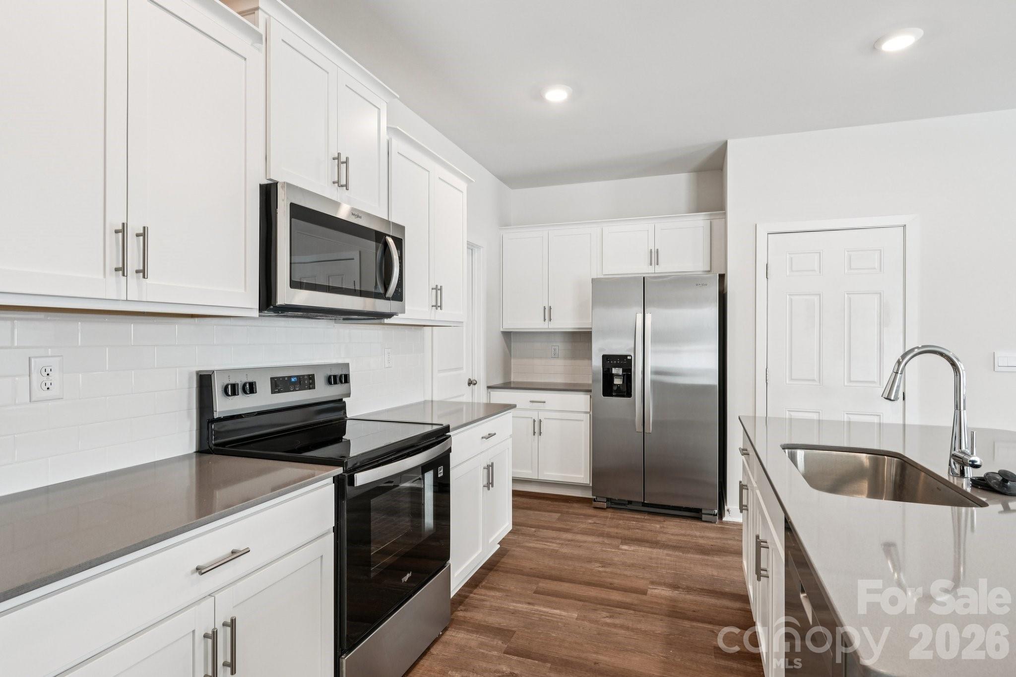 1430 Mammoth Road Hickory, NC 28602 - Photo 10 of 42 a kitchen with a sink stainless steel appliances and white cabinets