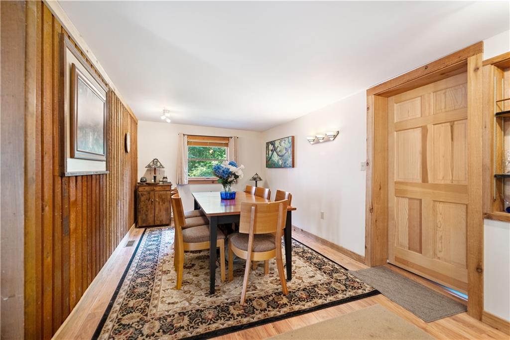 67 Spruce Peak Road Acme, PA 15610 - Photo 13 of 38 a dining room with wooden floor and a rug