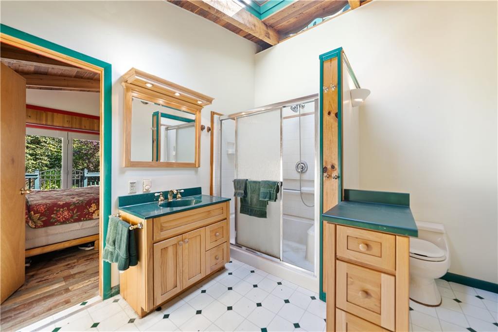 67 Spruce Peak Road Acme, PA 15610 - Photo 20 of 38 a bathroom with a granite countertop sink a toilet and shower