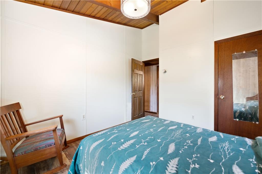 67 Spruce Peak Road Acme, PA 15610 - Photo 26 of 38 a bedroom with a bed and a chair