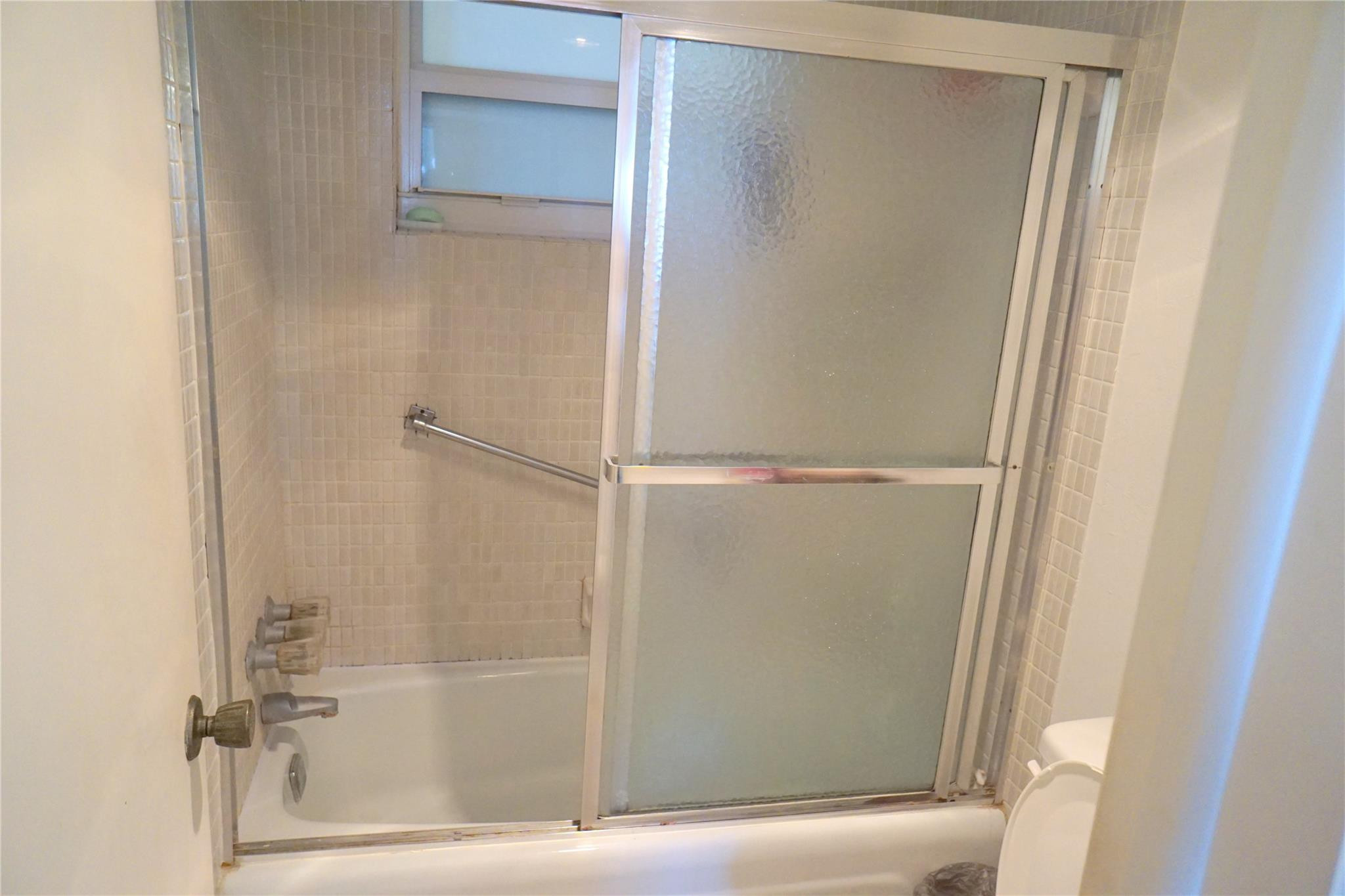 303 North Riverside Drive, Unit PH4 Pompano Beach, FL 33062 - Photo 21 of 52 a bathroom with a glass shower door