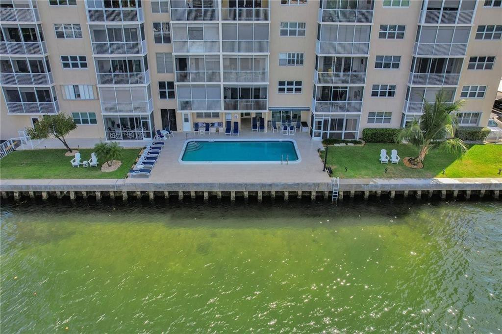 303 North Riverside Drive, Unit PH4 Pompano Beach, FL 33062 - Photo 36 of 52 a table and chairs sitting in the water next to a building