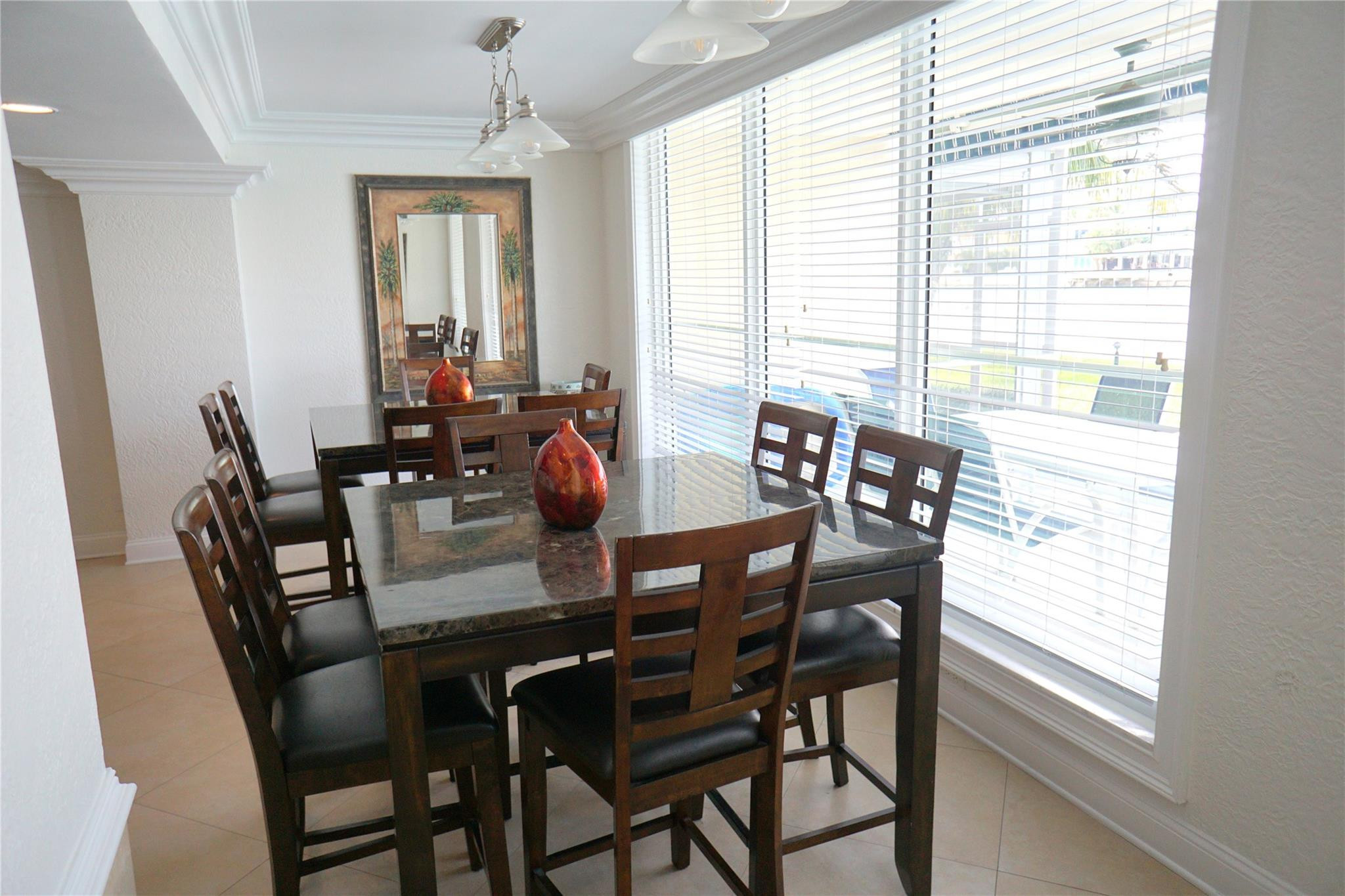 303 North Riverside Drive, Unit PH4 Pompano Beach, FL 33062 - Photo 46 of 52 a view of a dining room with furniture and windows