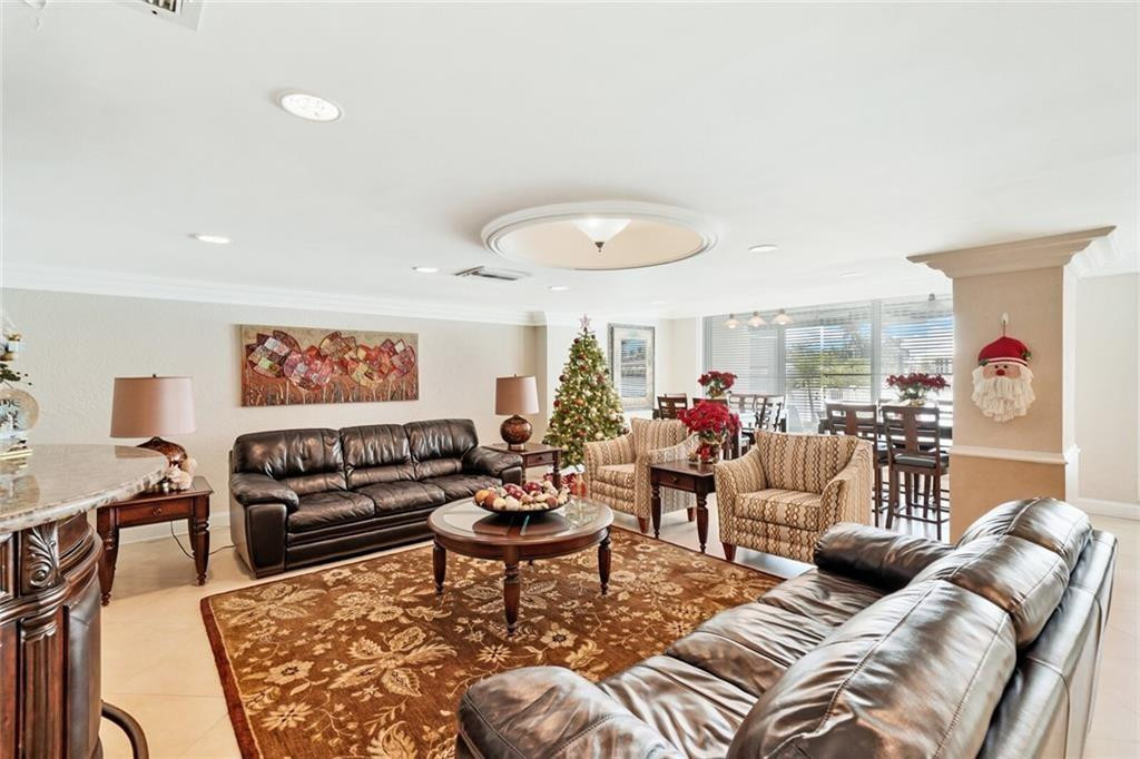 303 North Riverside Drive, Unit PH4 Pompano Beach, FL 33062 - Photo 5 of 52 a living room with furniture a rug and a window