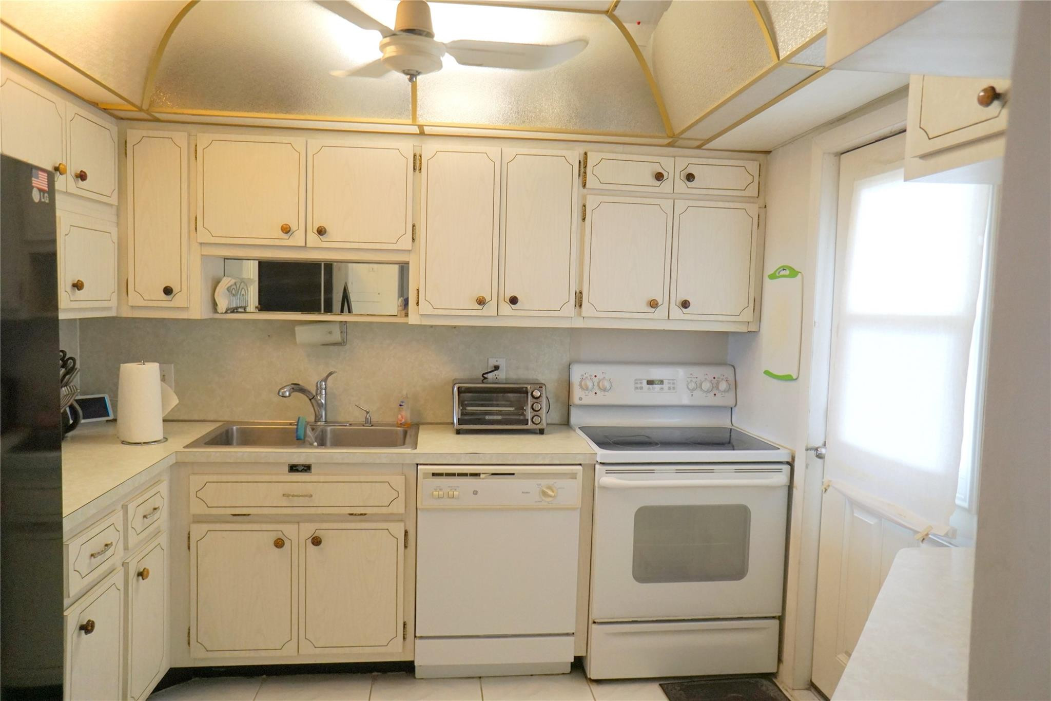303 North Riverside Drive, Unit PH4 Pompano Beach, FL 33062 - Photo 10 of 52 a view of white cabinets and sink