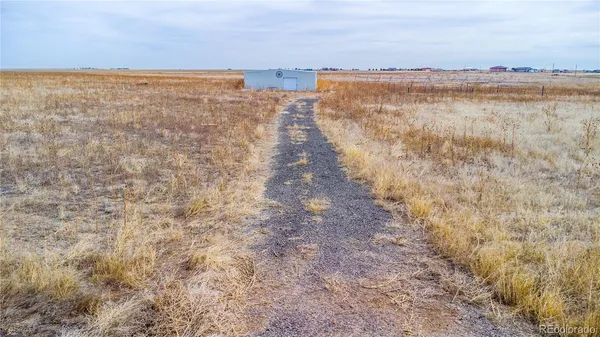 a view of a lake with houses in the back