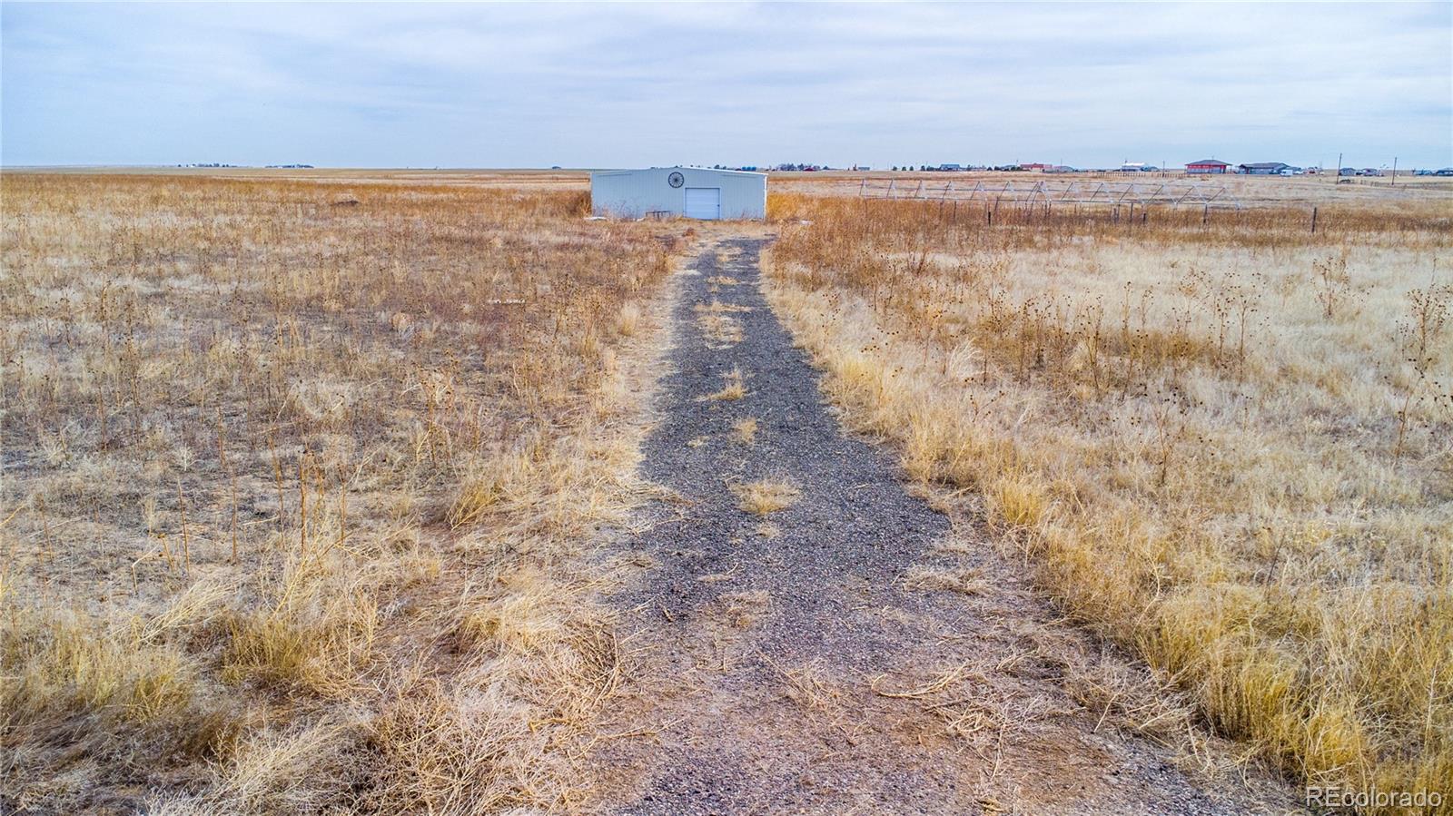 11300 Penrith Road Bennett, CO 80102 - Photo 3 of 9 a view of a lake with houses in the back