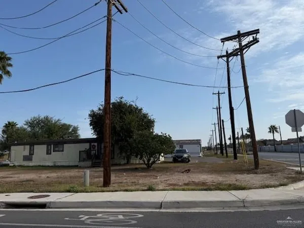 a view of a street with a cars parked on the road