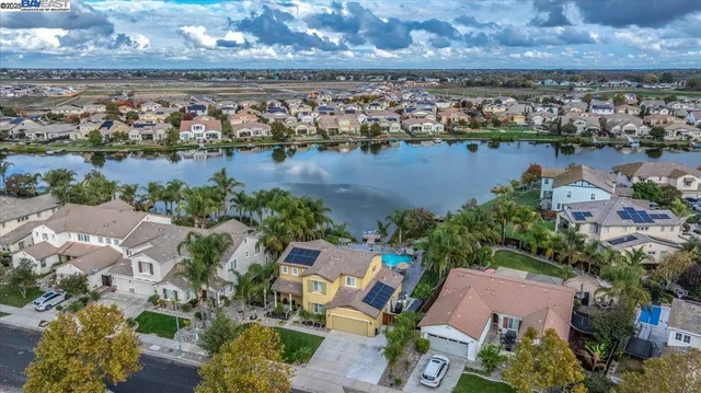 an aerial view of residential building with outdoor space and lake view