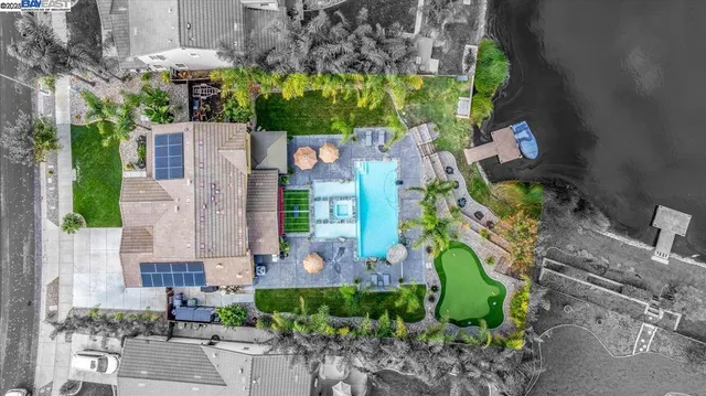 an aerial view of a house with a yard and garden