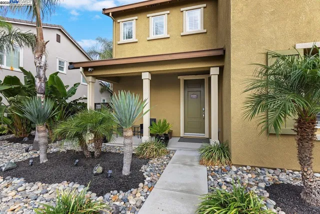 a front view of a house with garden