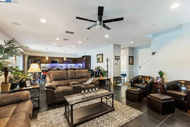 a living room with furniture and a ceiling fan