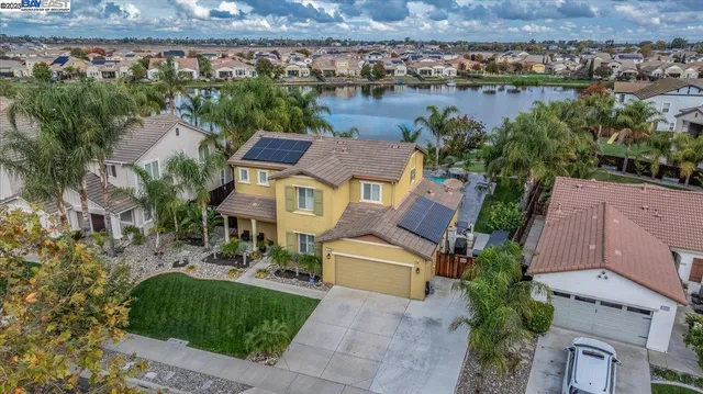 a aerial view of a house with outdoor space and lake view