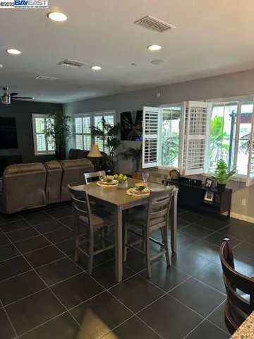 a view of a dining room with furniture window and outside view