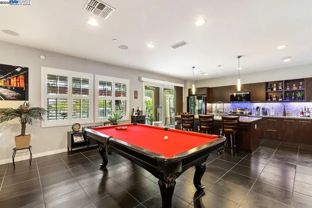 a room with furniture pool table and flat screen tv