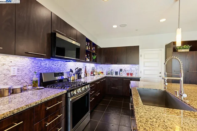 a kitchen with stainless steel appliances a sink and a stove