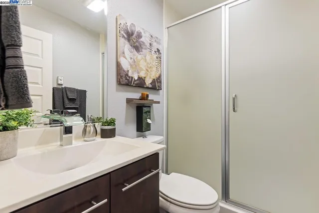 a bathroom with a sink a toilet and mirror