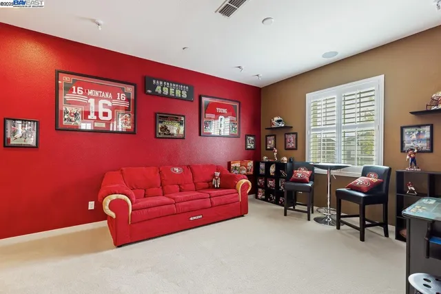 a living room with furniture a piano and a window