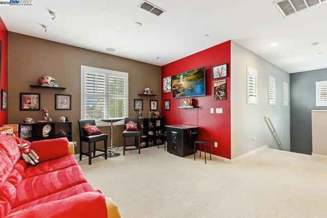 a bed room with furniture and a flat screen tv
