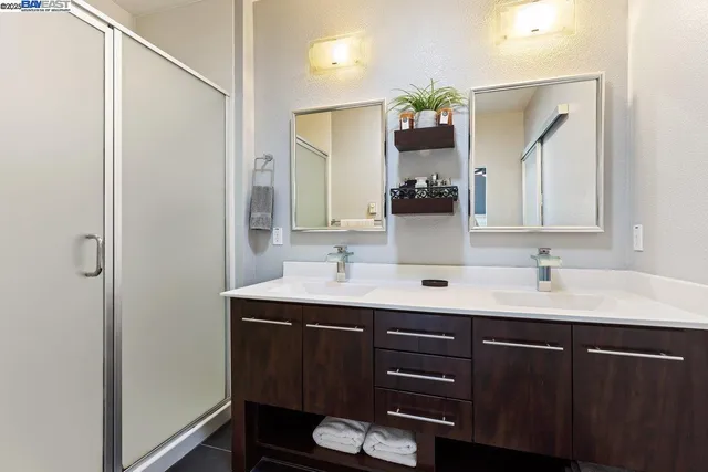 a bathroom with a double vanity sink and a mirror