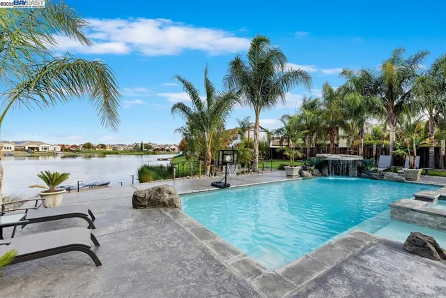 a view of a swimming pool and lounge chair