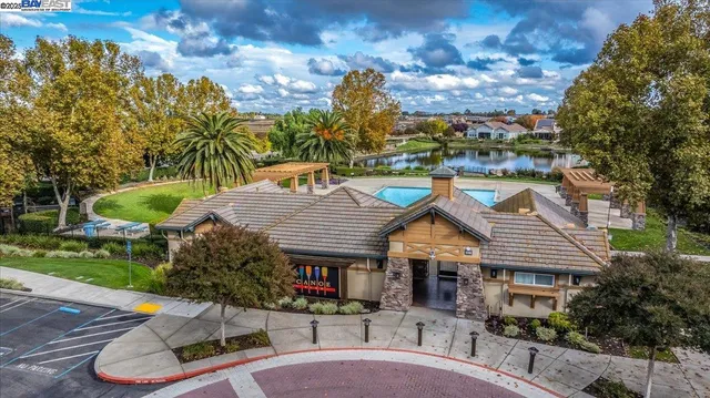 a front view of a house with a yard and potted plants