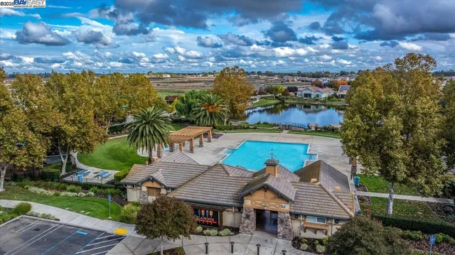 an aerial view of a house with a yard basket ball court and outdoor seating