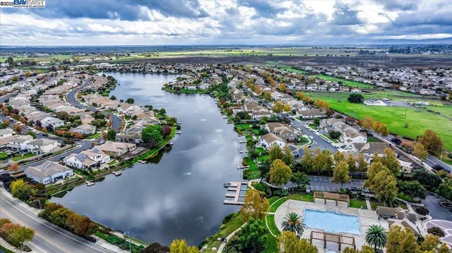an aerial view of residential houses with outdoor space and river