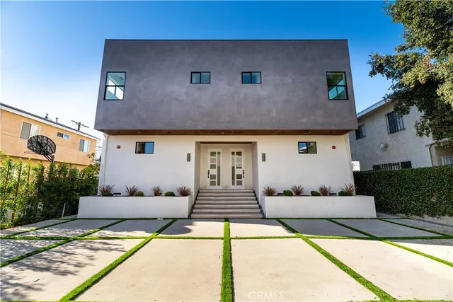 a front view of a house with white walls