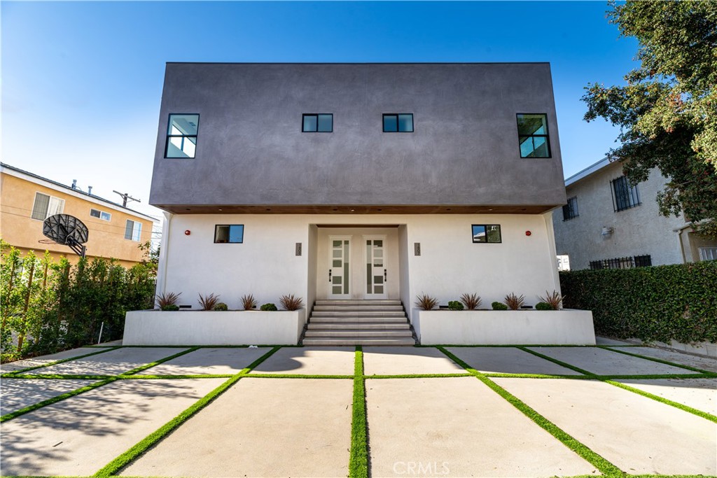 a front view of a house with white walls