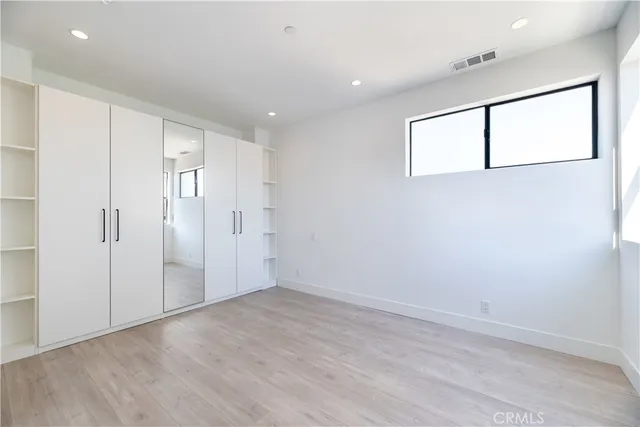 a bathroom with a double vanity sink toilet mirror and shower