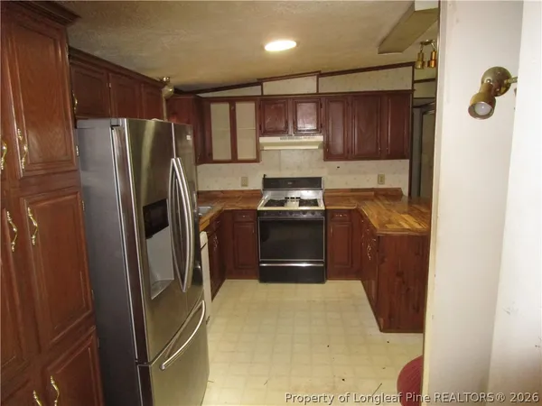 a kitchen with a refrigerator sink and stove