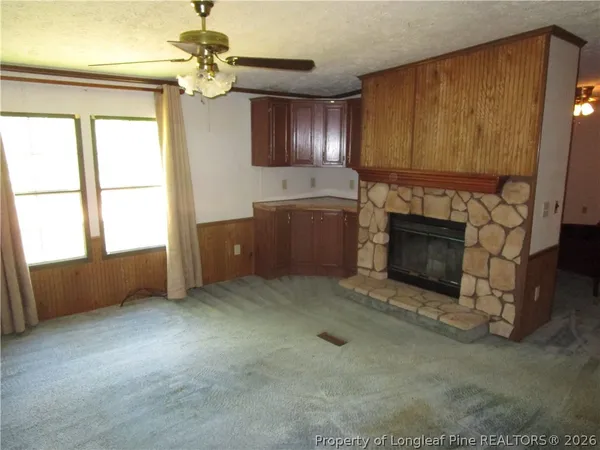 a living room with furniture and a fireplace