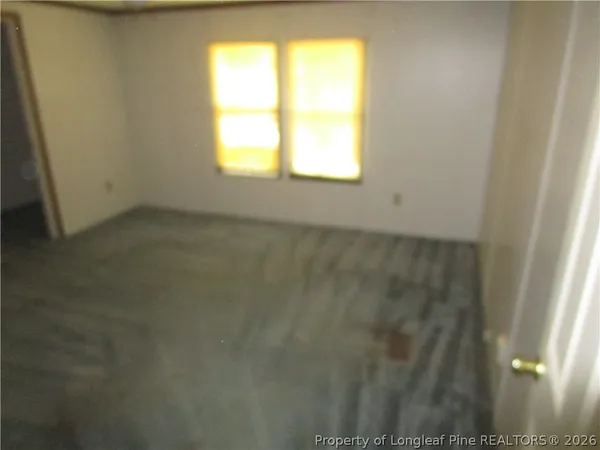 a view of an empty room and a window