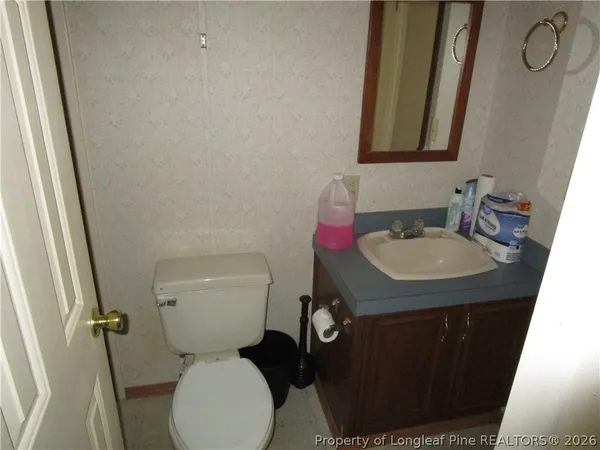 a bathroom with a toilet sink and mirror