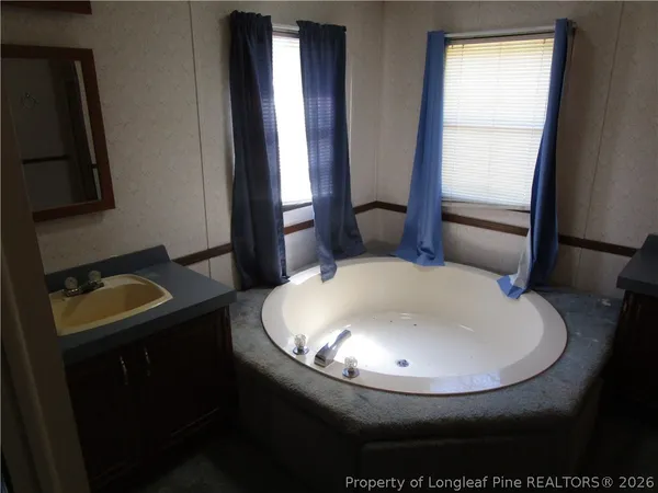 a bathroom with a sink toilet and mirror
